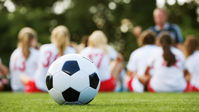 stack.com – halftime.png coach giving speech to girls soccer team at halftime