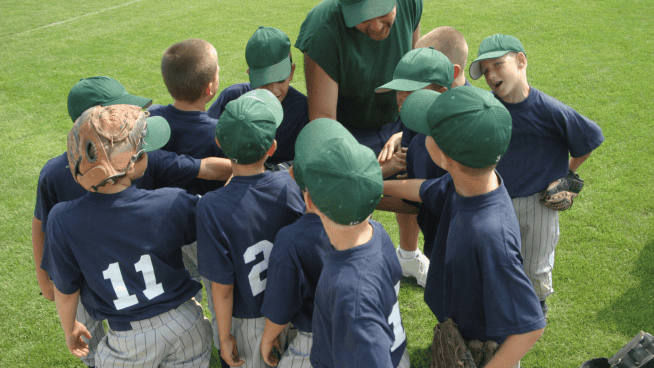 stack.com – youth sports youth sports male baseball team in huddle with coach